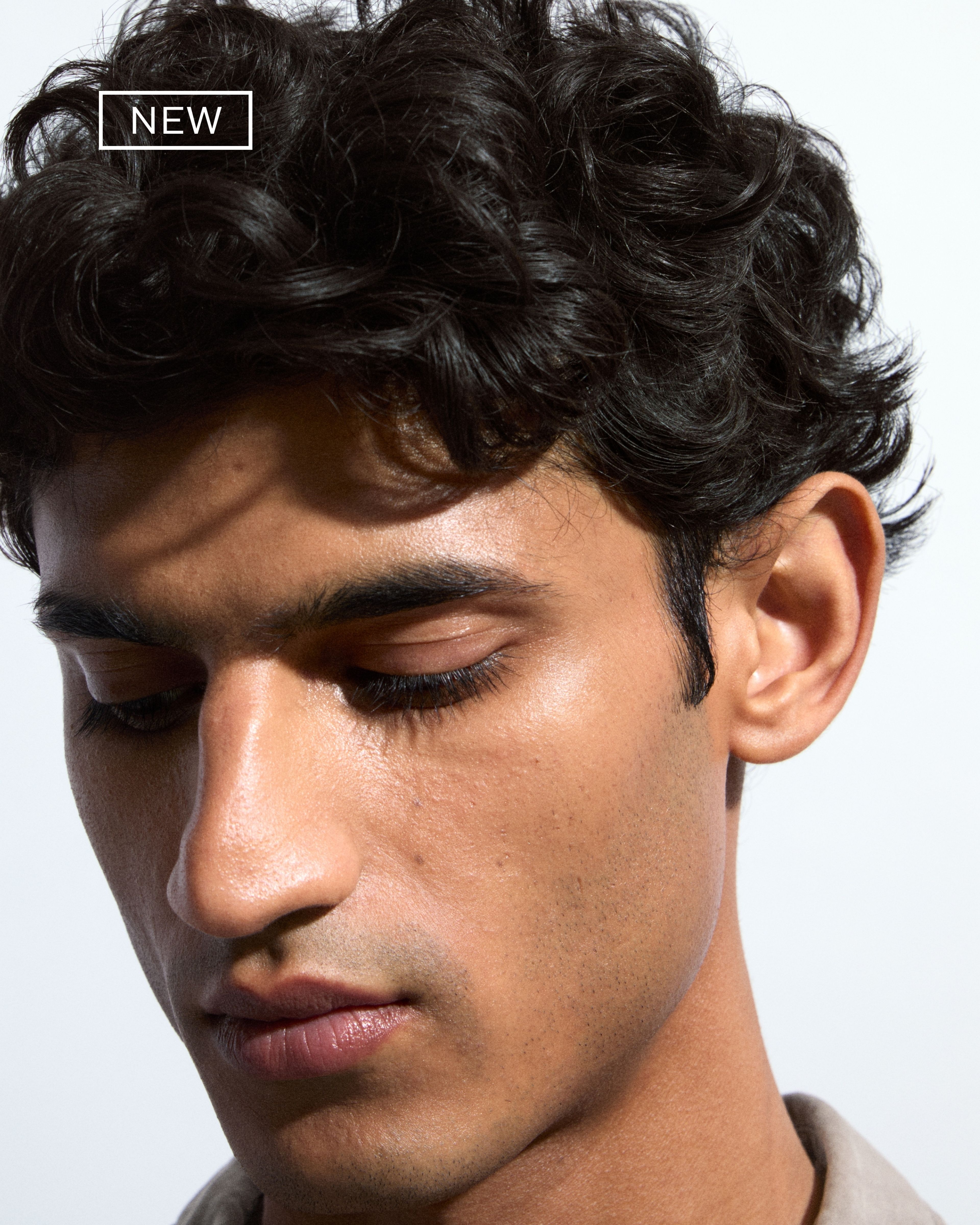Men's kit of make up products laying on grey background