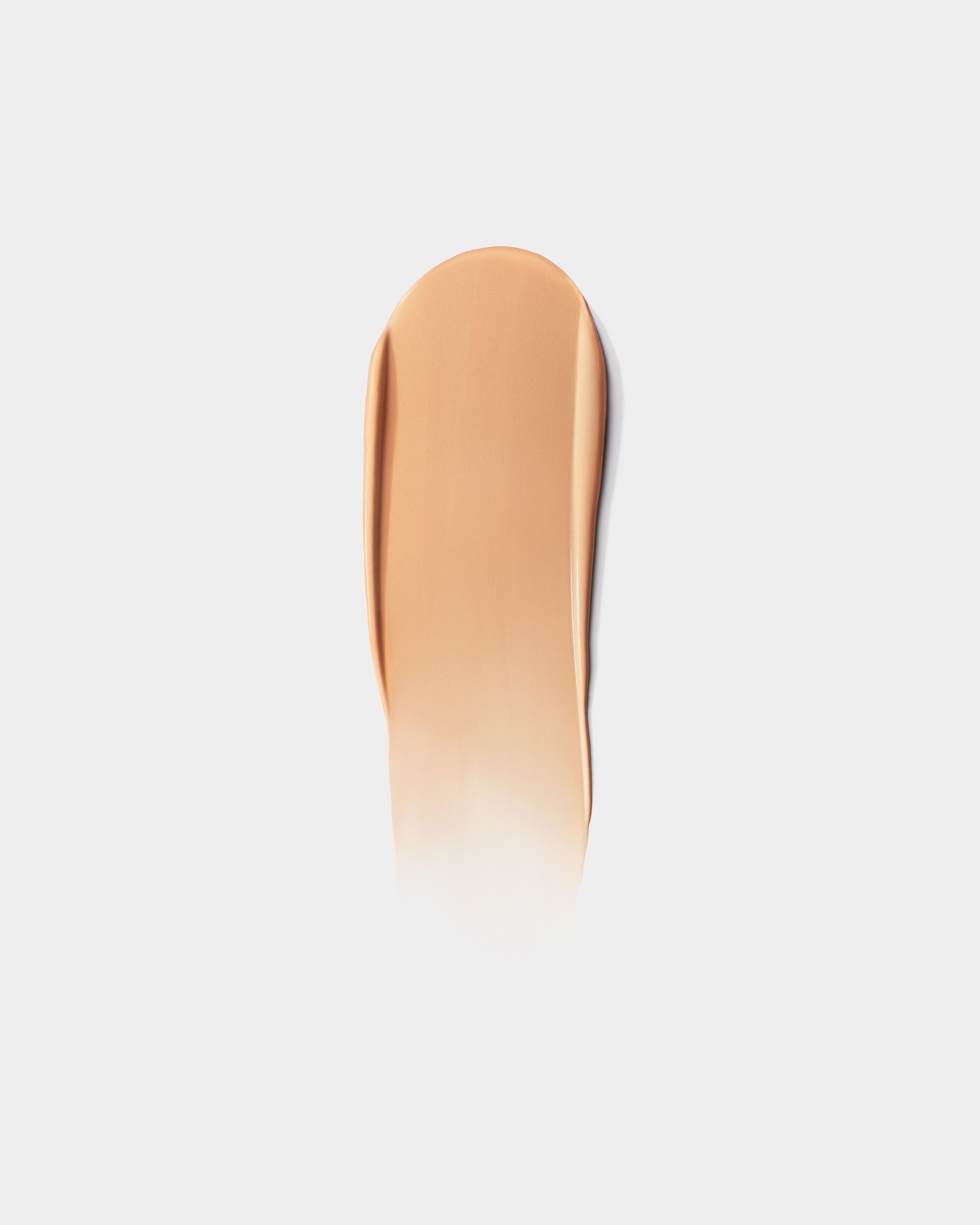 Moisturizer case and refill laying on a grey surface