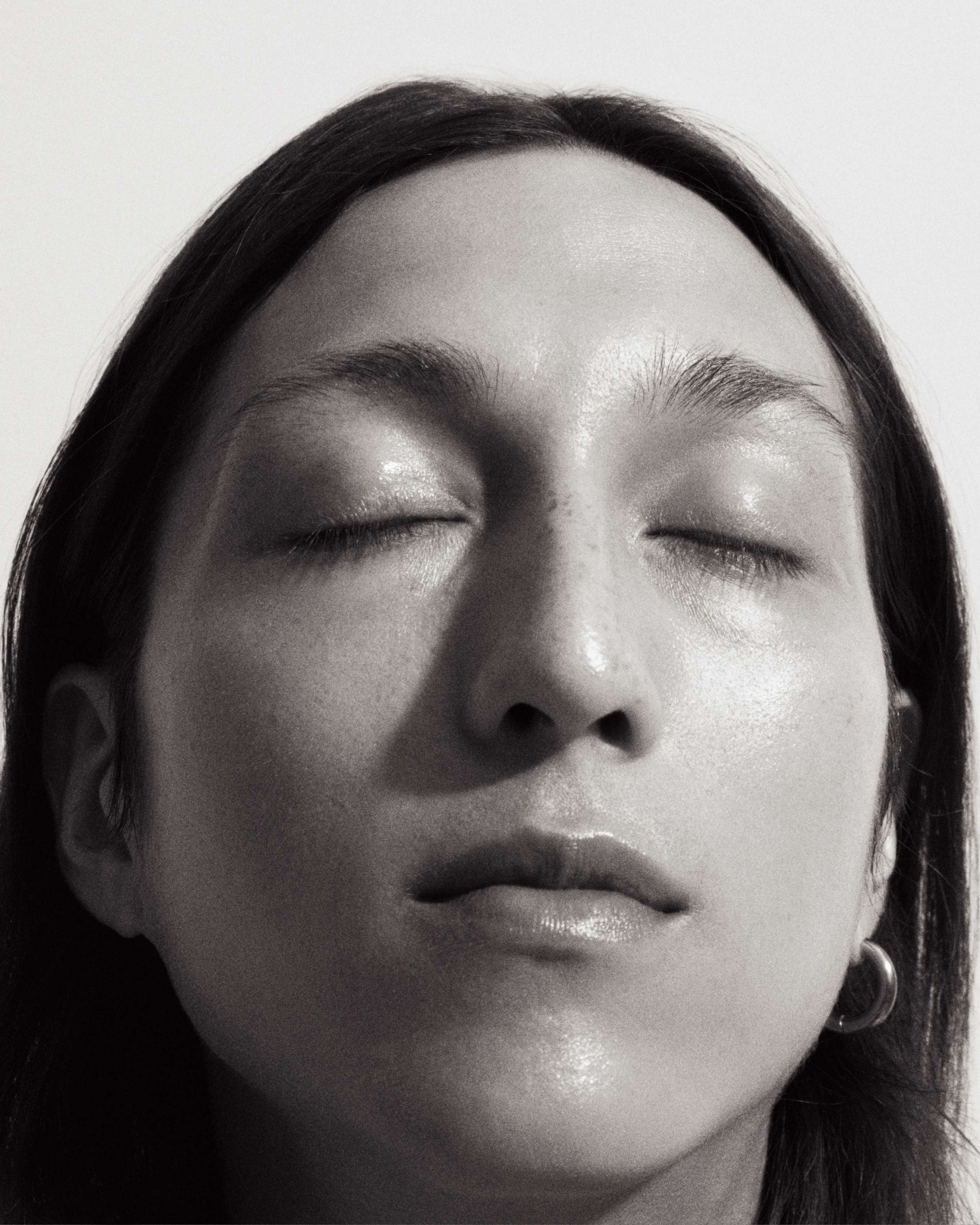 Black and white image of a man with closed eyes