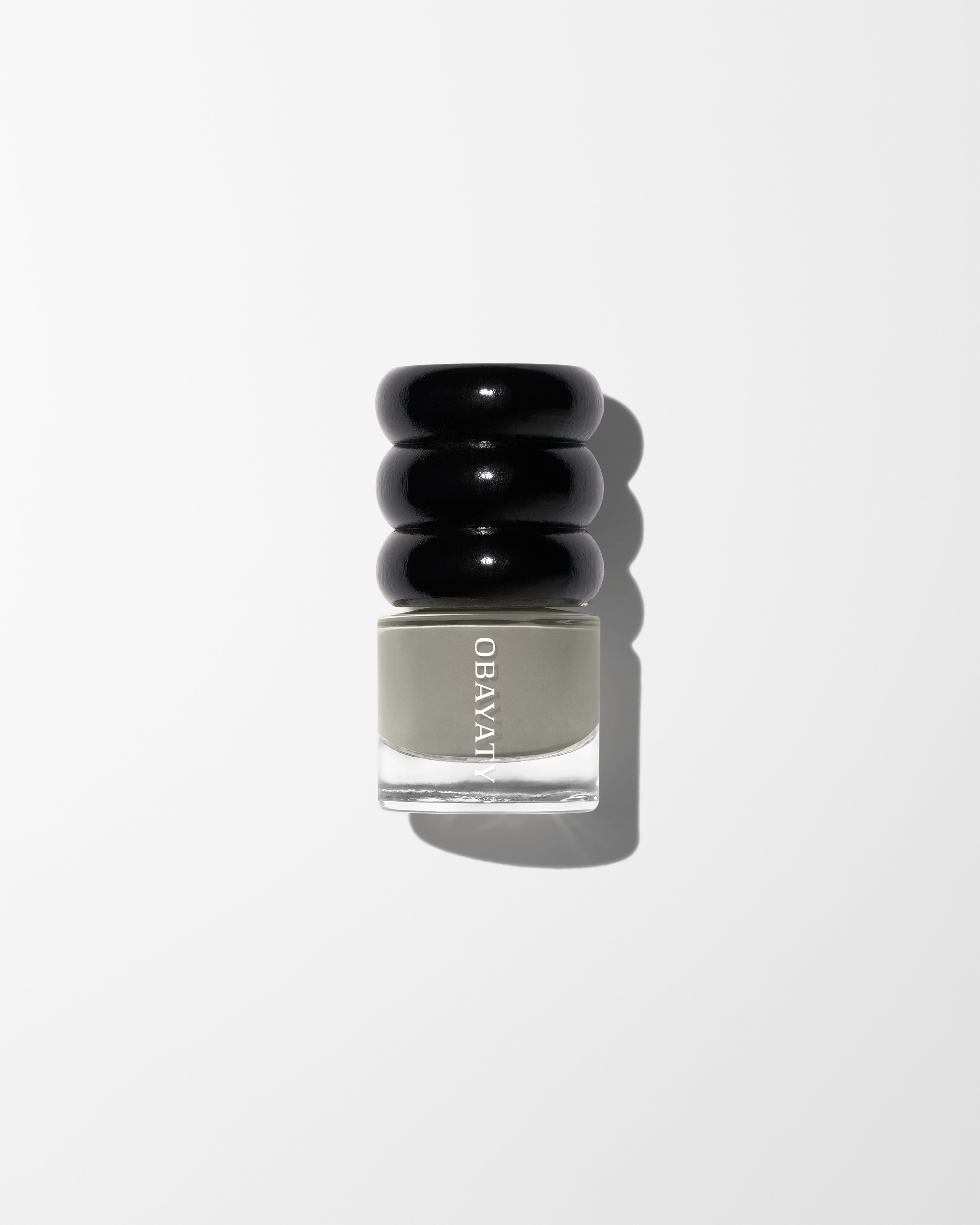 Nail polish in the colour Lunar laying on a grey surface