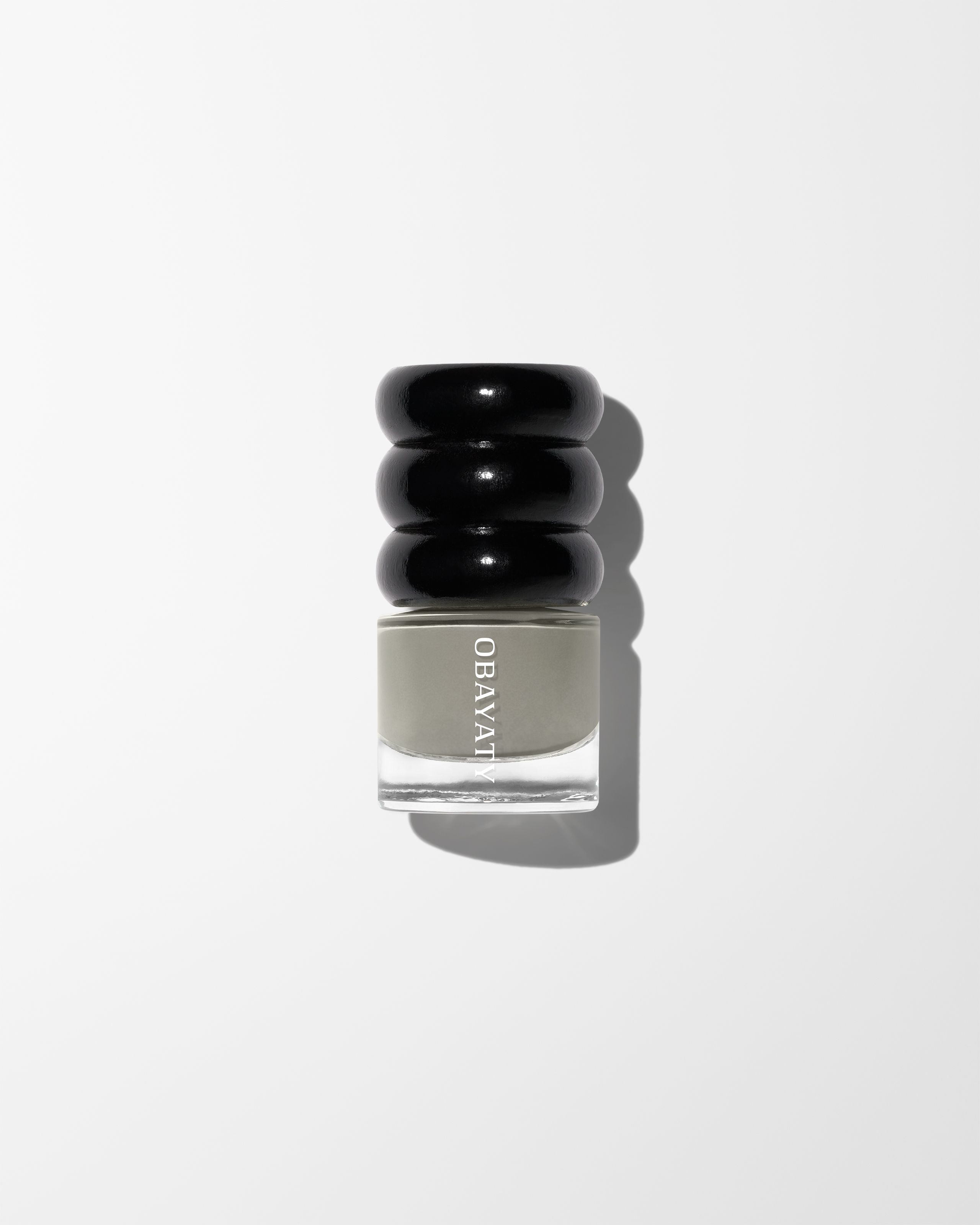 Nail polish in the colour Lunar laying on a grey surface