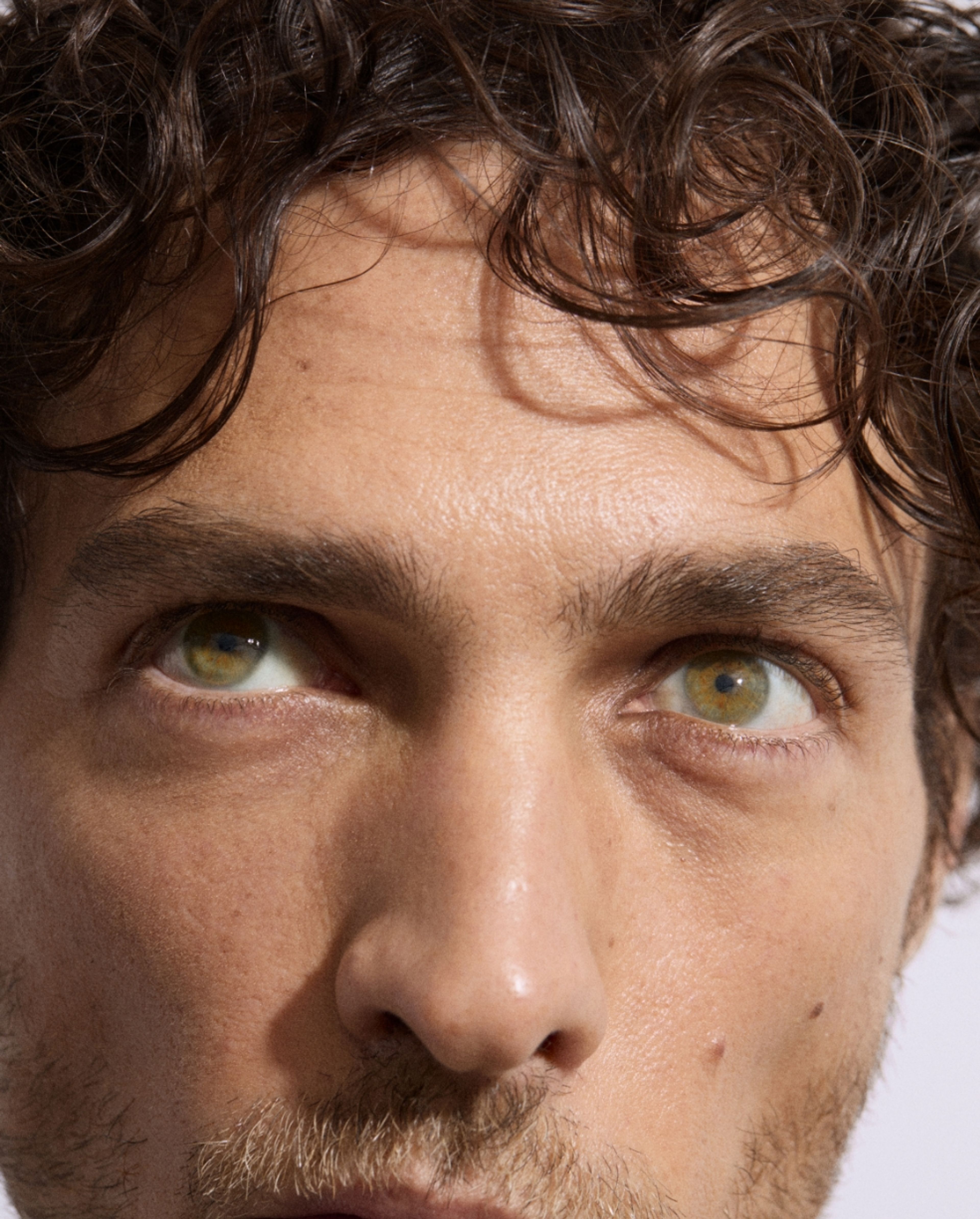 Man looking into camera wearing brow beard pen