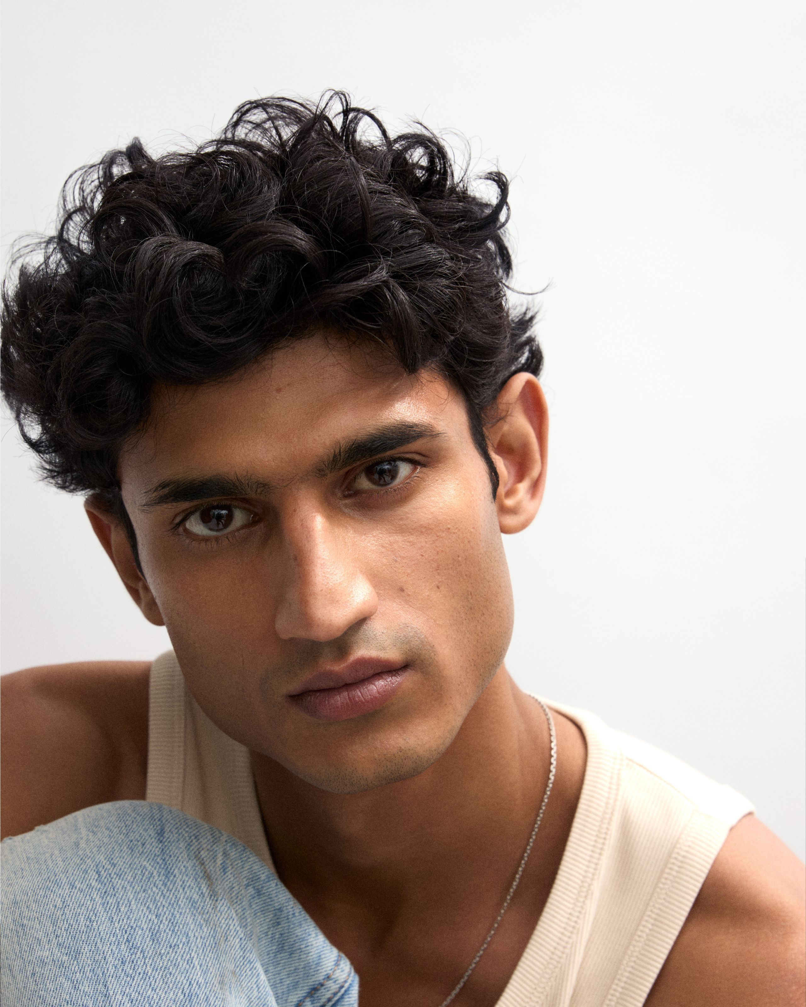 Model with tinted eye cream applied