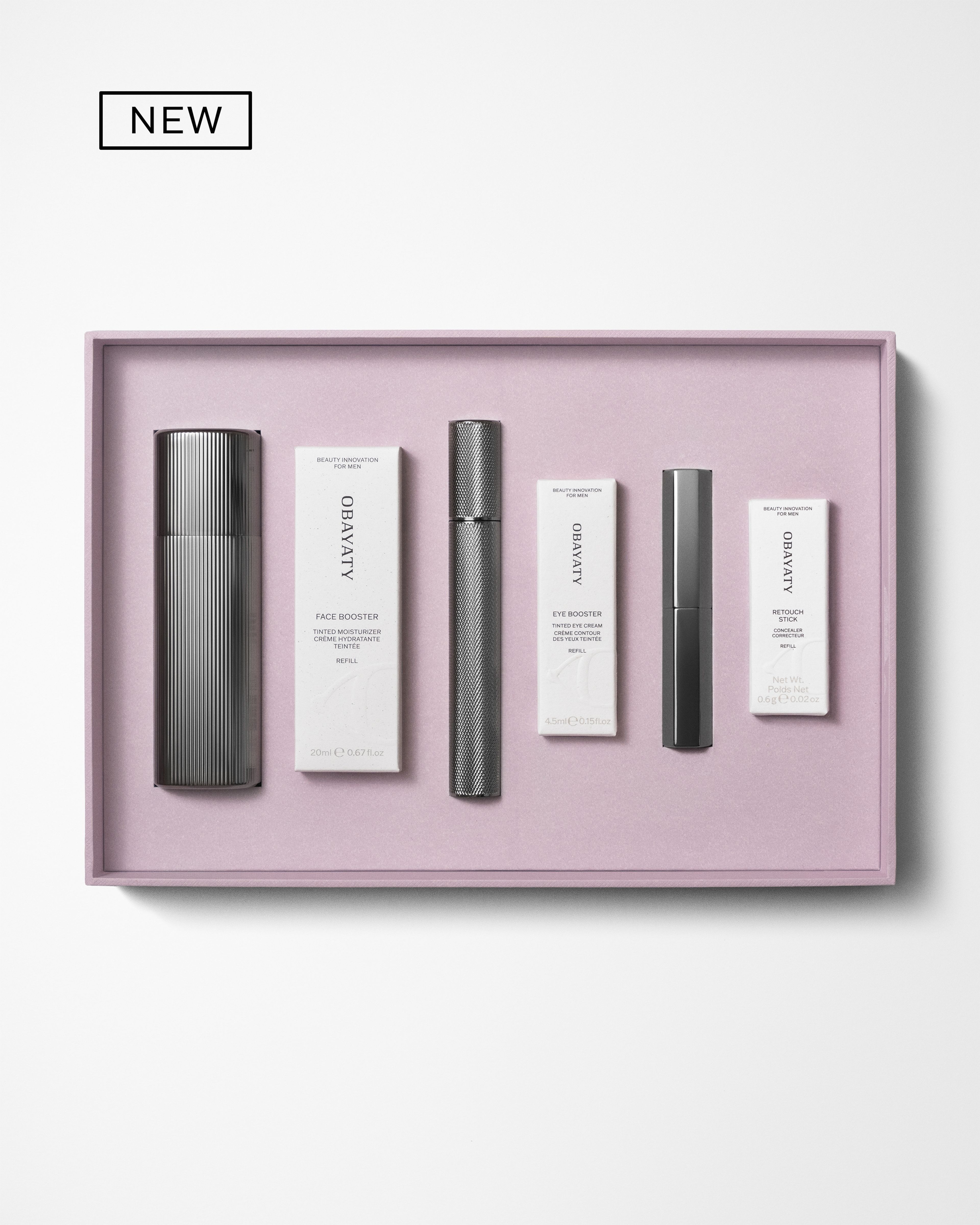 Men's make up kit laying on a grey background