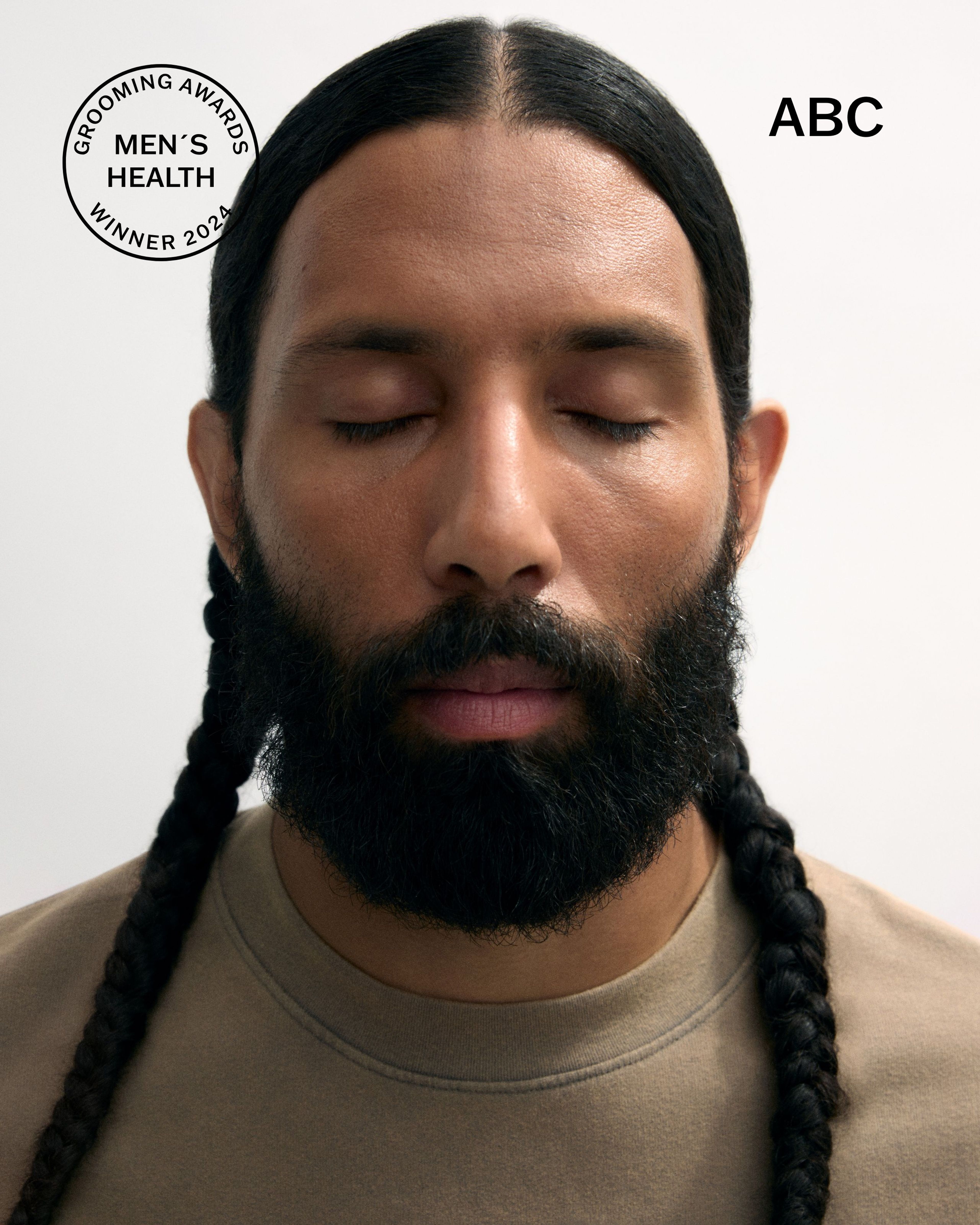 Men's tinted moisturizer and concealer laying on a grey surface