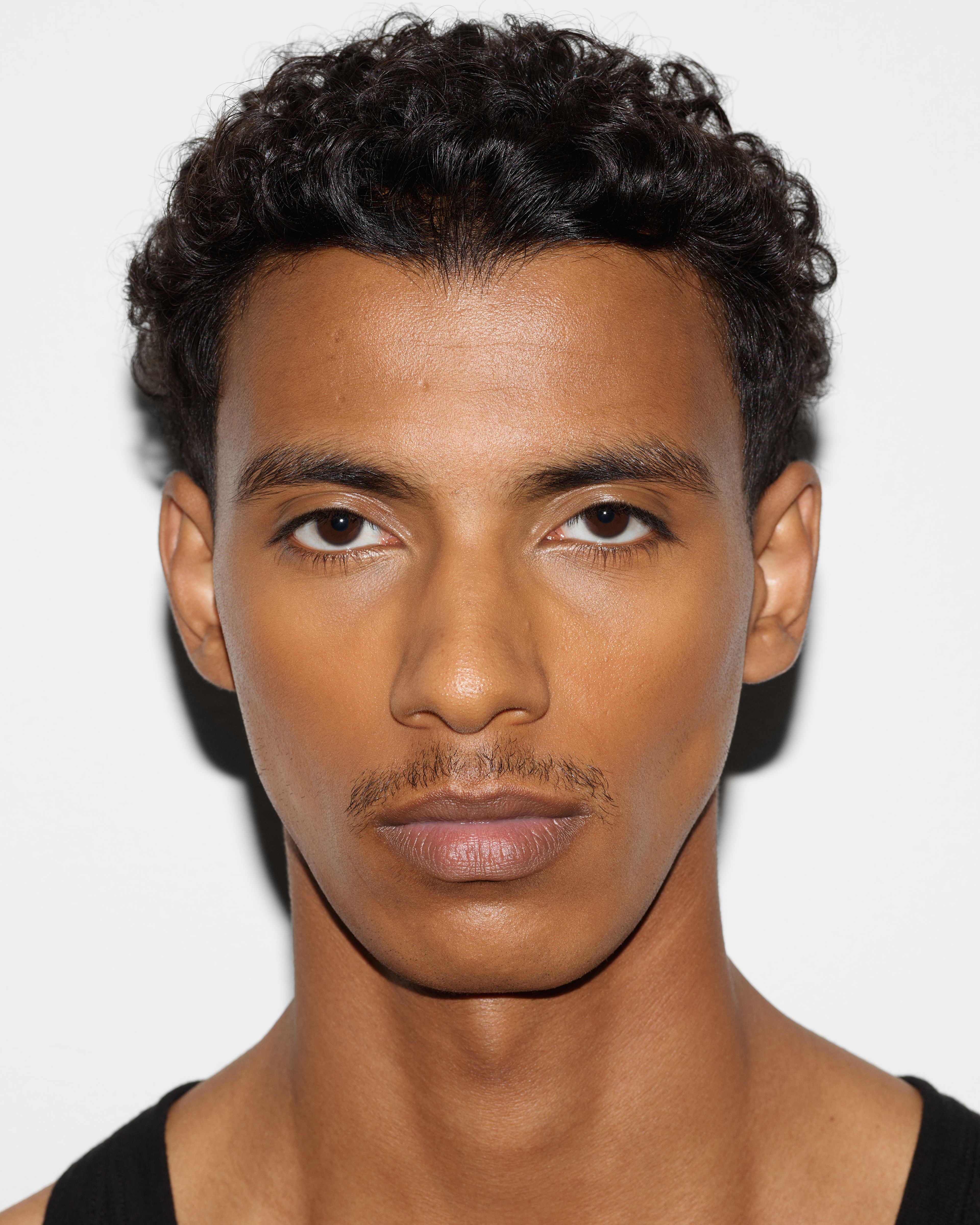 Man looking in to the camera with face contour applied
