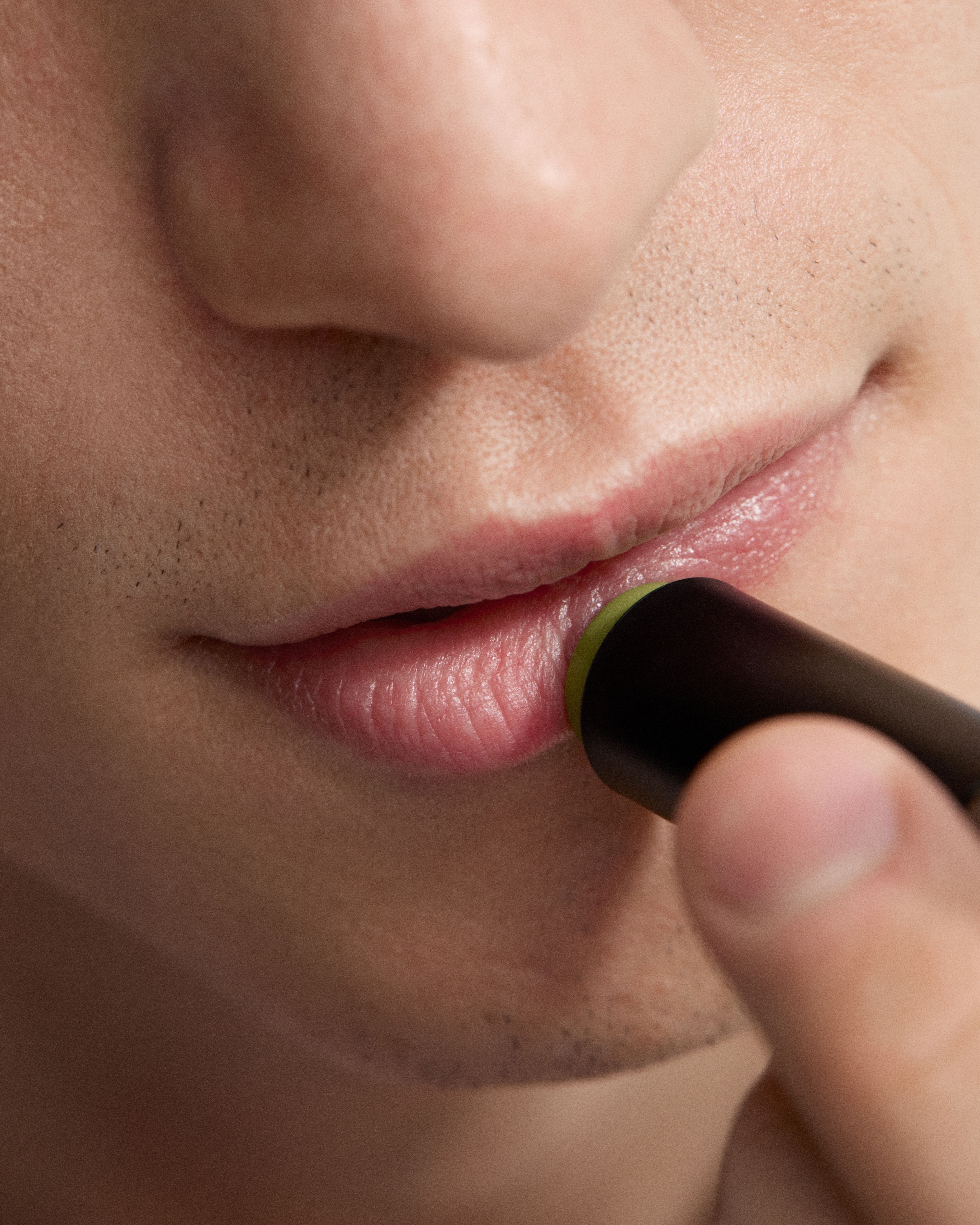 Image of man applying lip balm