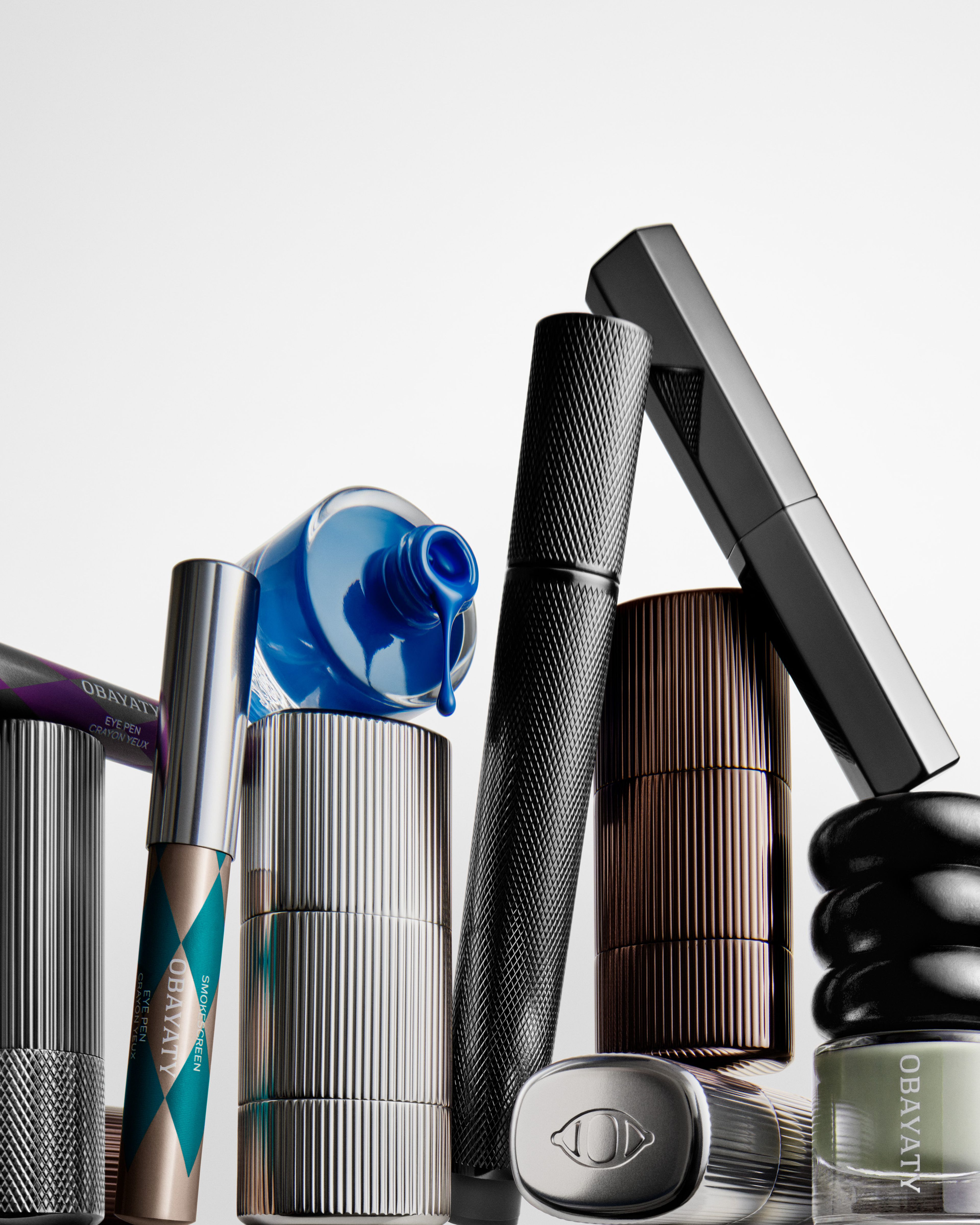 A group of several make up products in different materials and forms in front of a white background