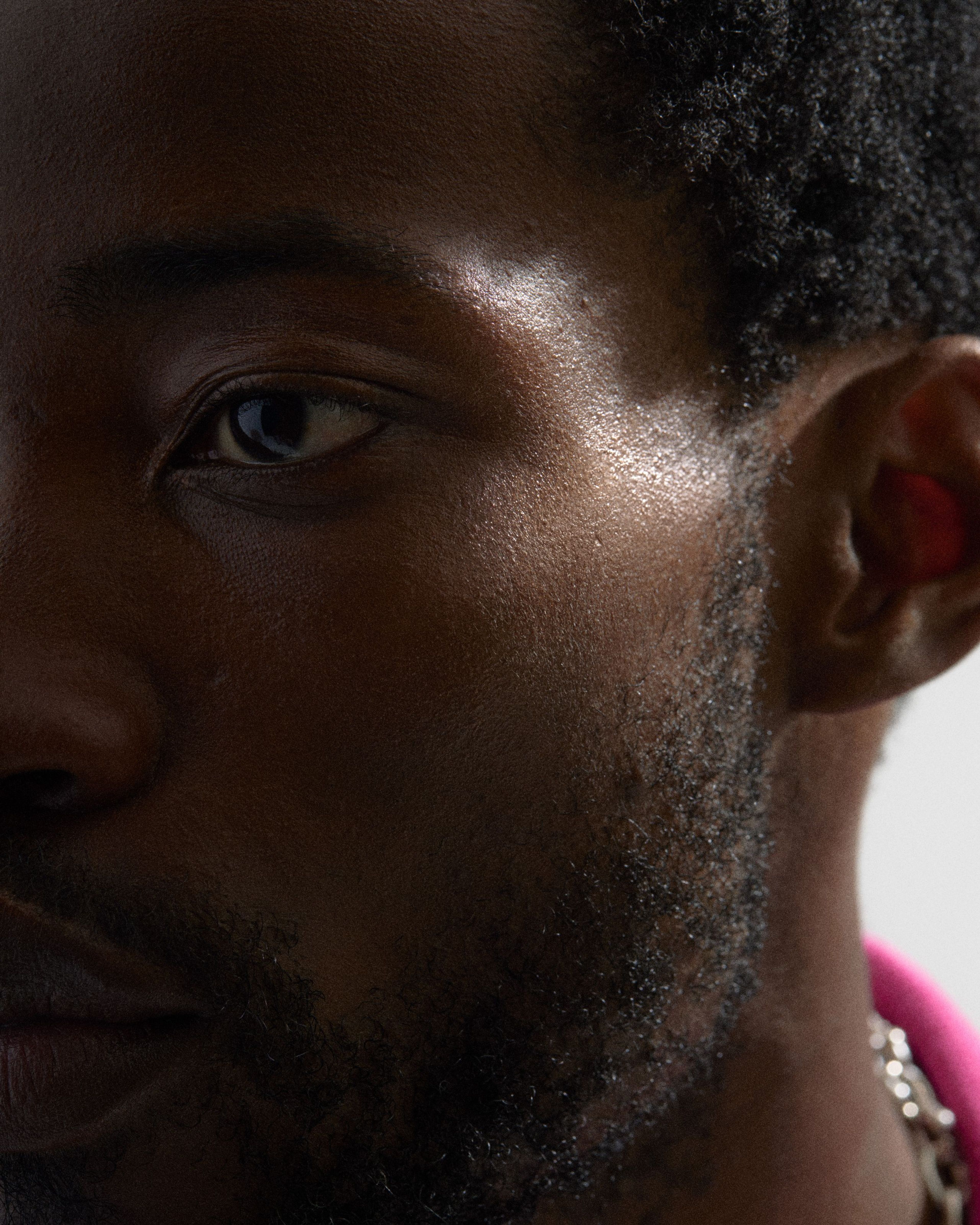 Man looking in to the camera with highlighter applied