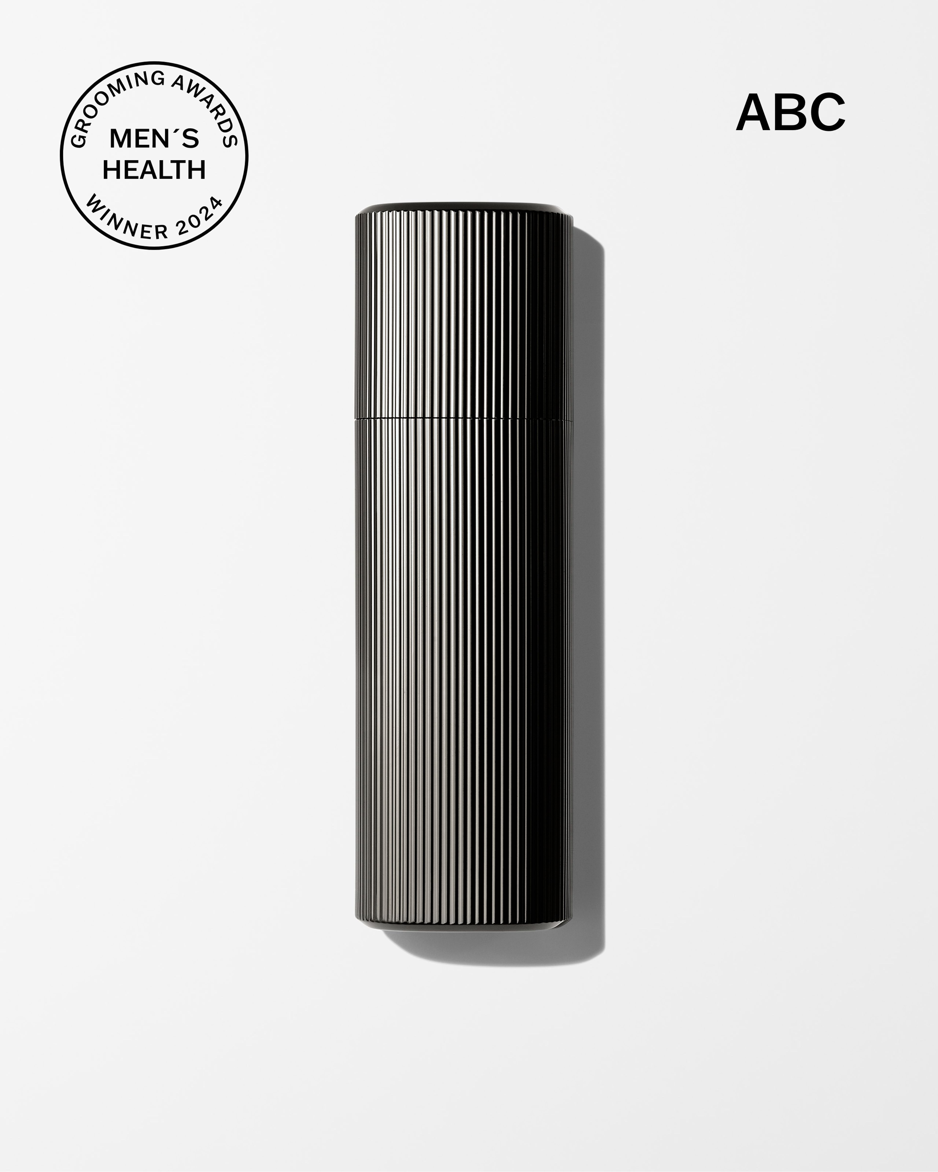 Men's tinted moisturizer and concealer laying on a grey surface