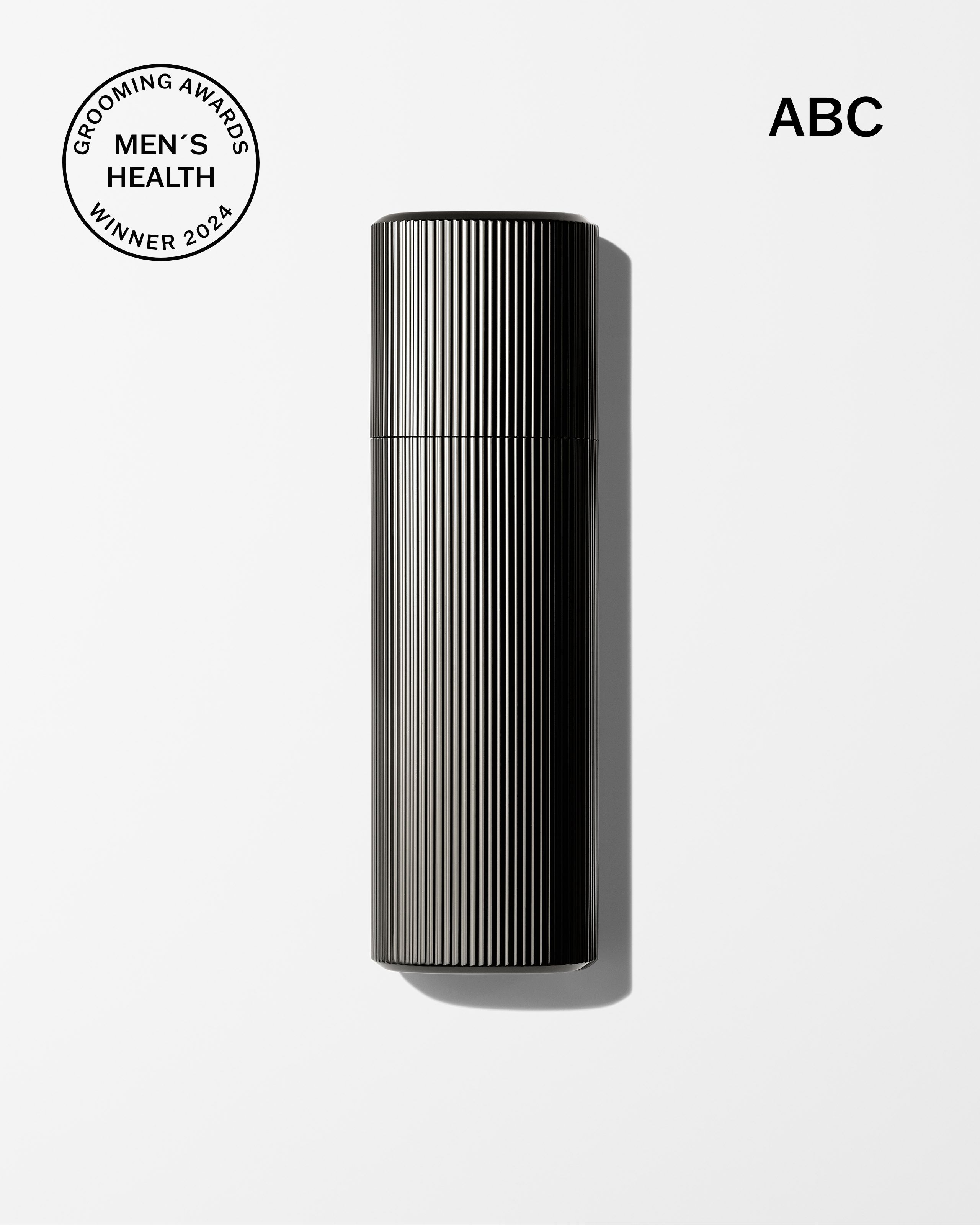 Men's tinted moisturizer and concealer laying on a grey surface