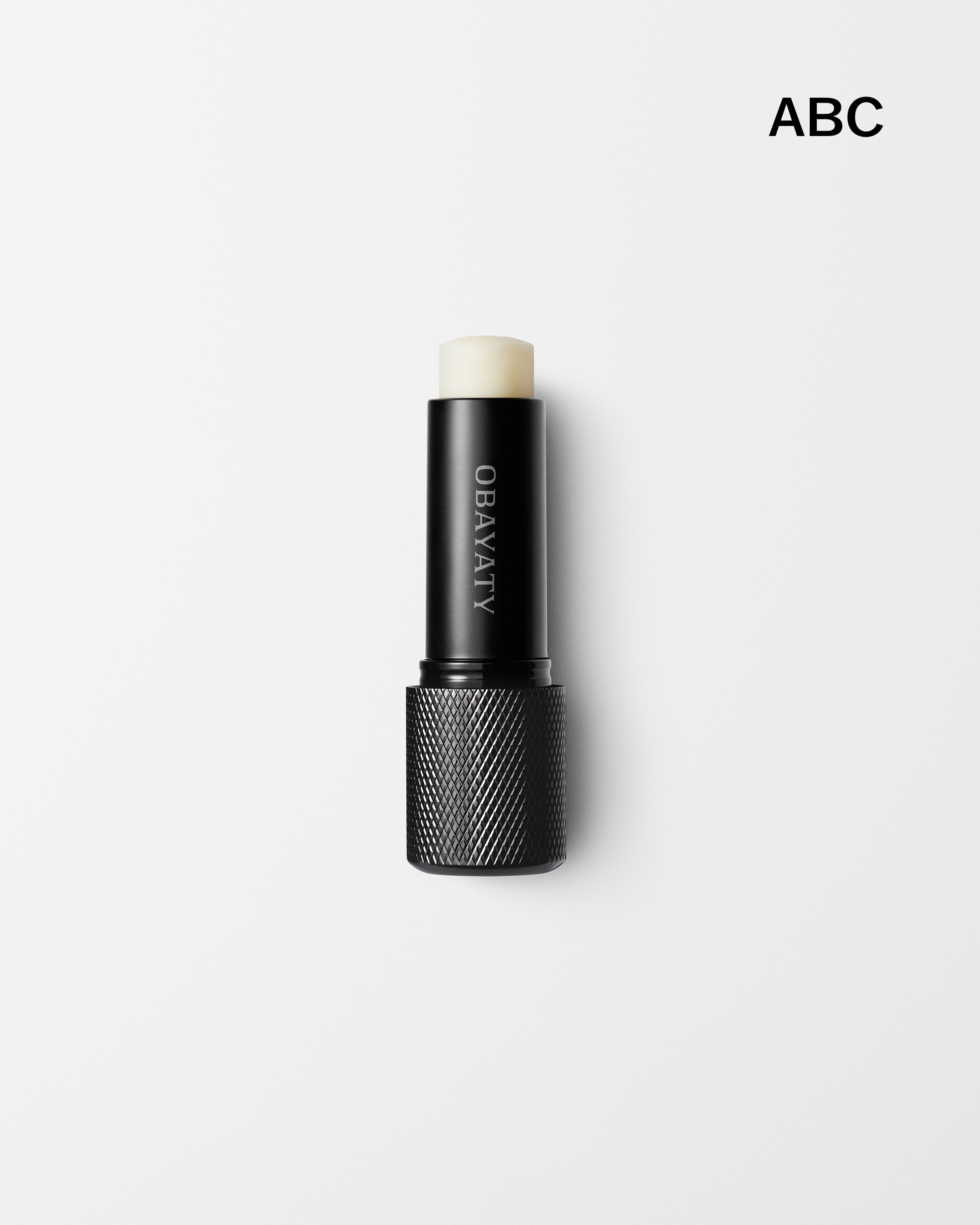Men's lip balm laying on a grey surface