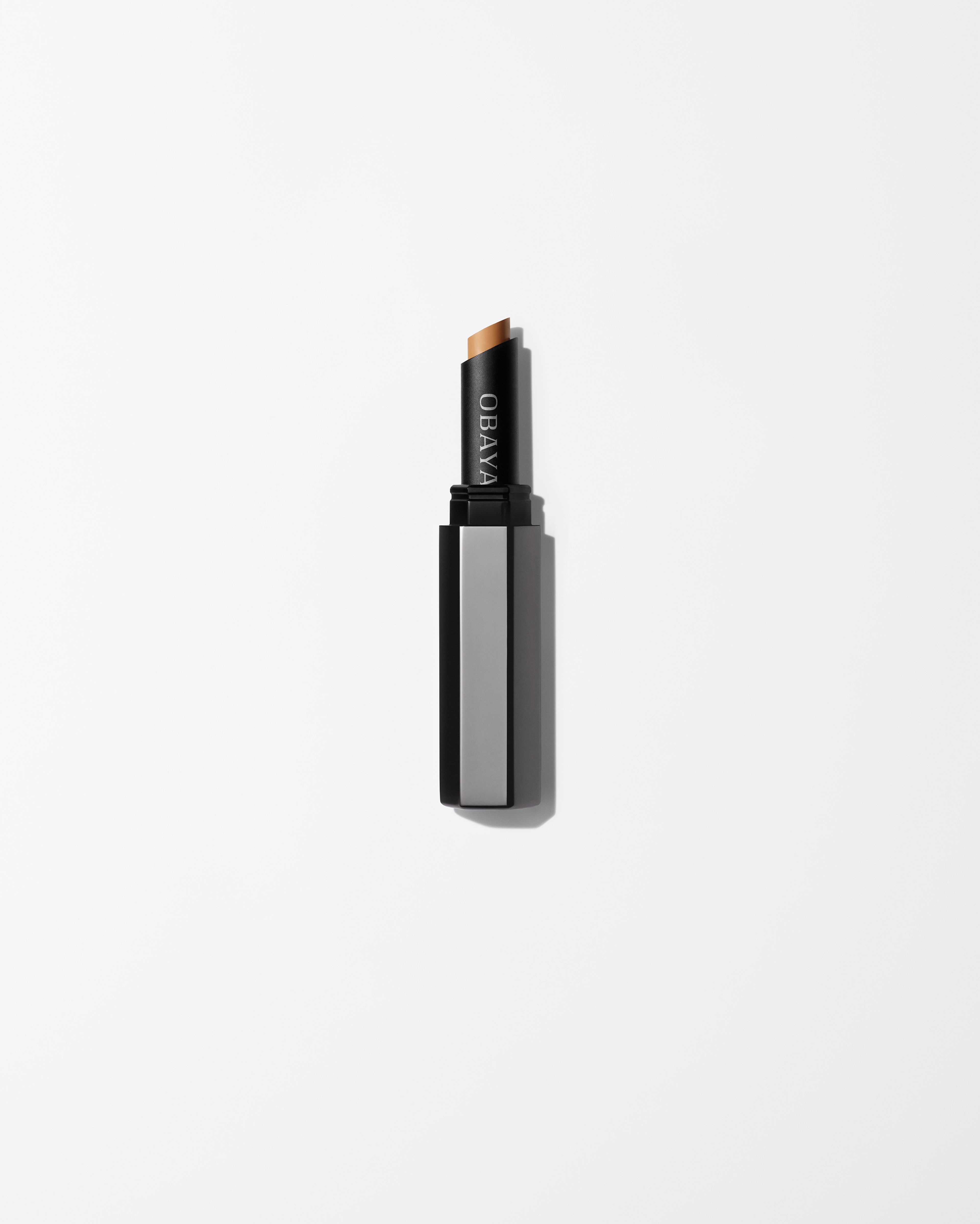 Men's concealer laying on a grey surface
