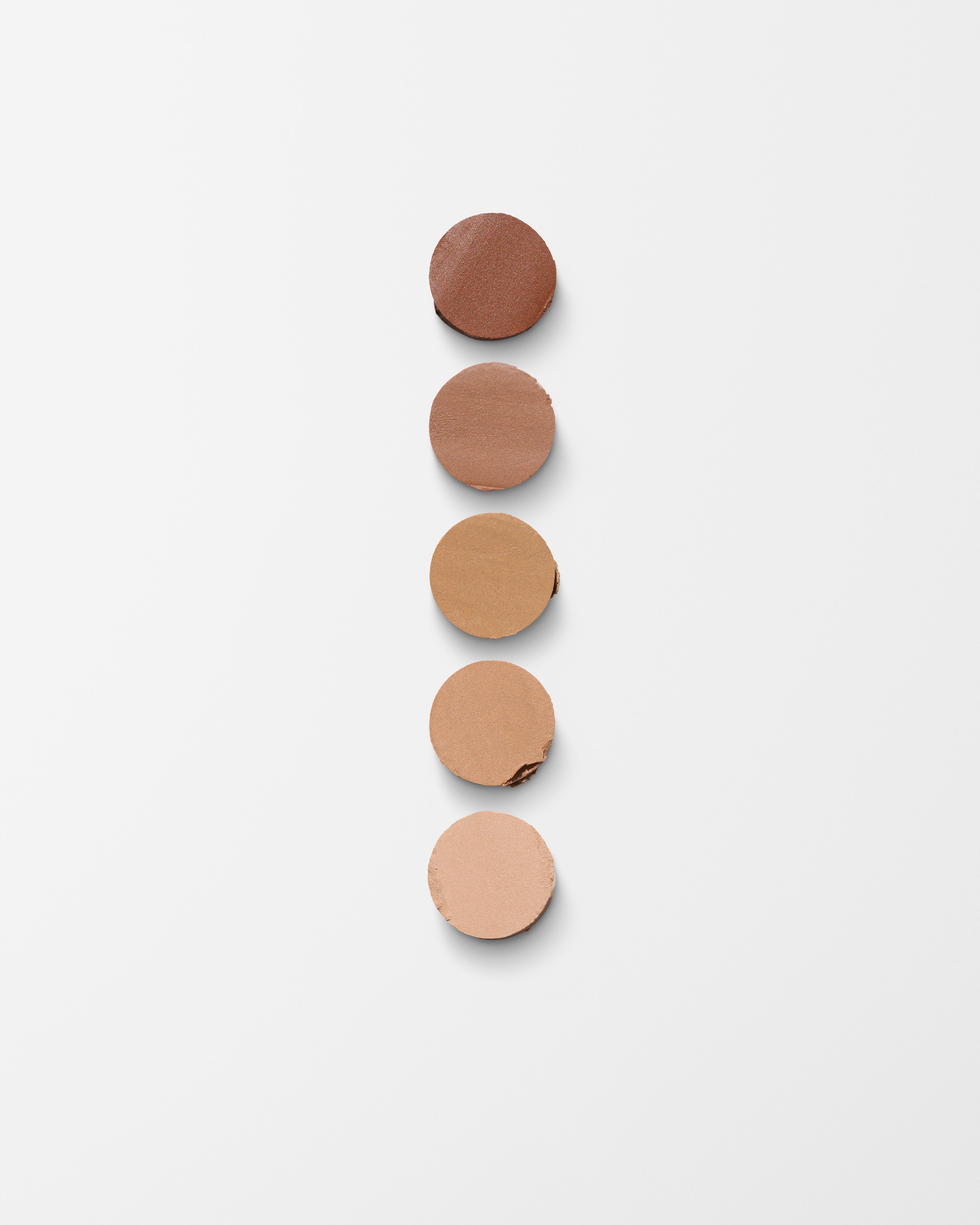Mens concealer refill laying on a grey surface