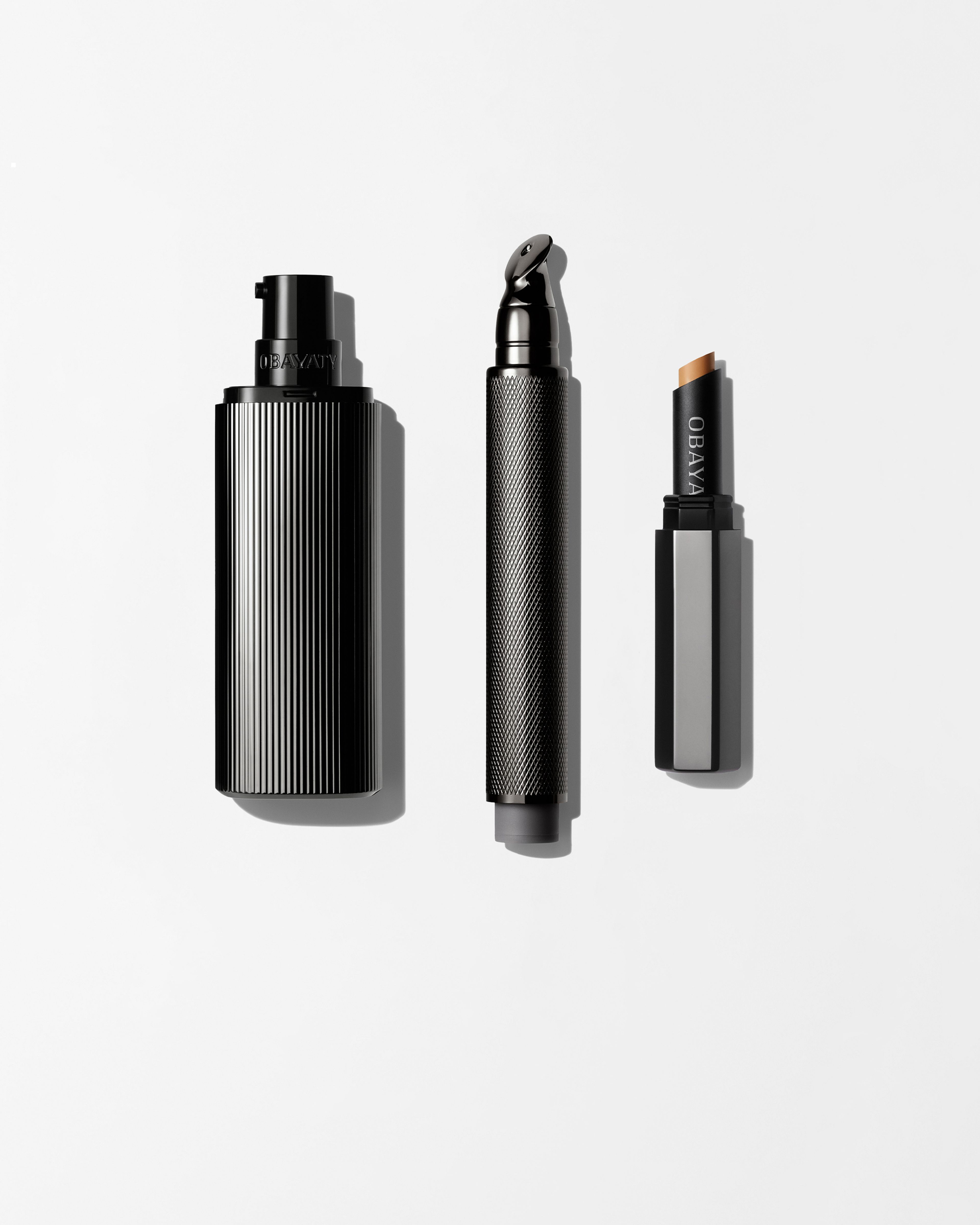 Men's make up kit laying on a grey background