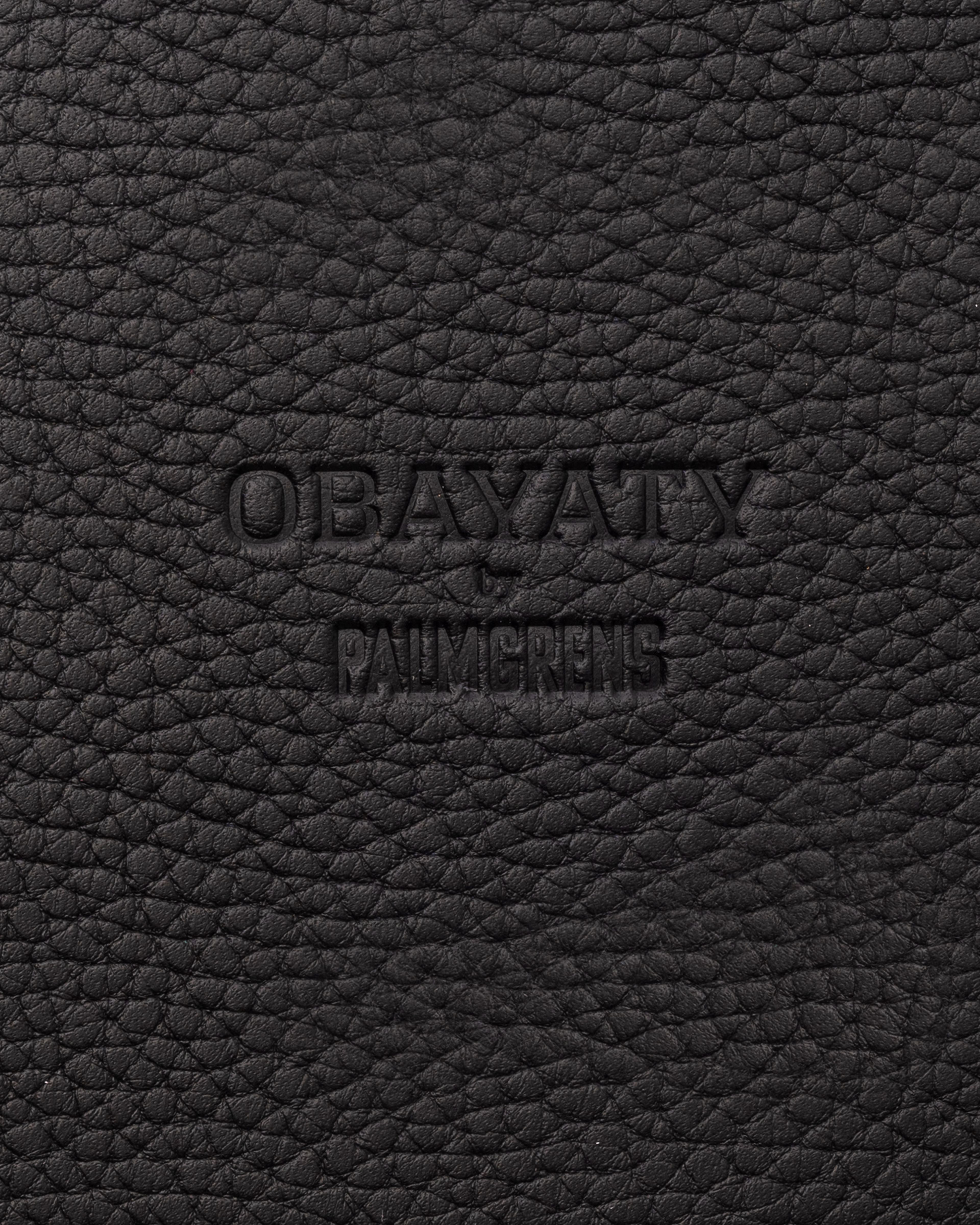 Obayaty by palmgrens embossed on a black leather surface