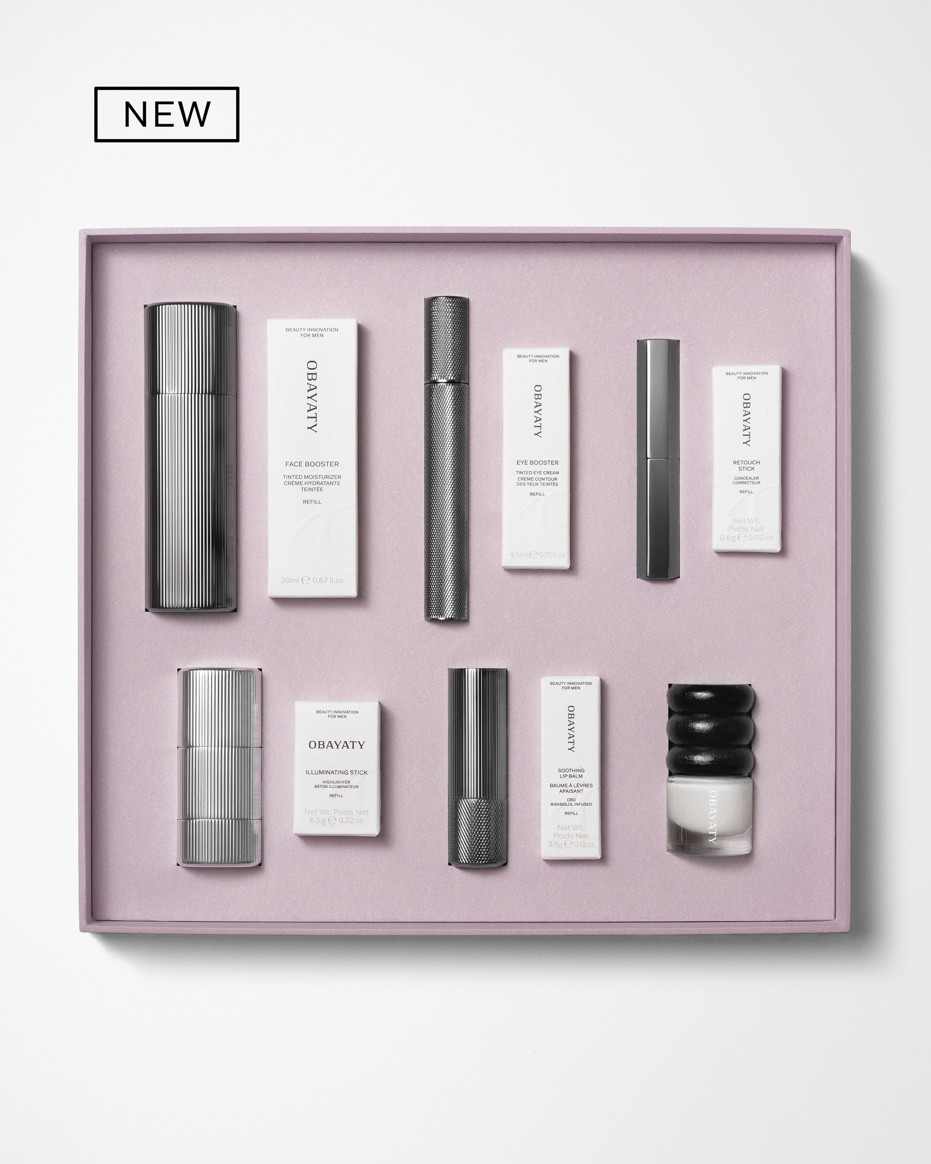 Men's make up kit laying on a grey background