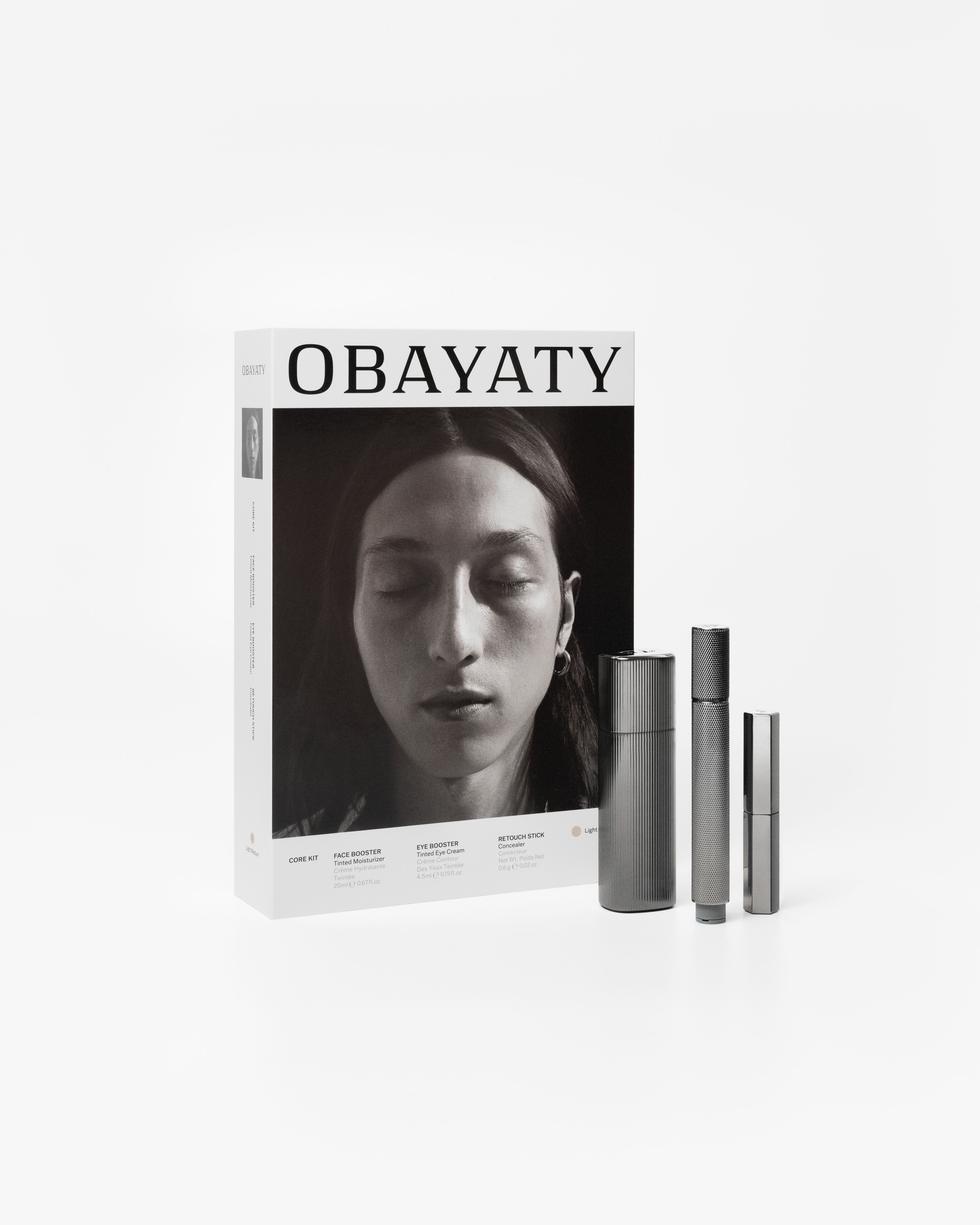 Men's Concealer, Tinted Moisturizer and Tinted Eye Cream Laying on a grey surface