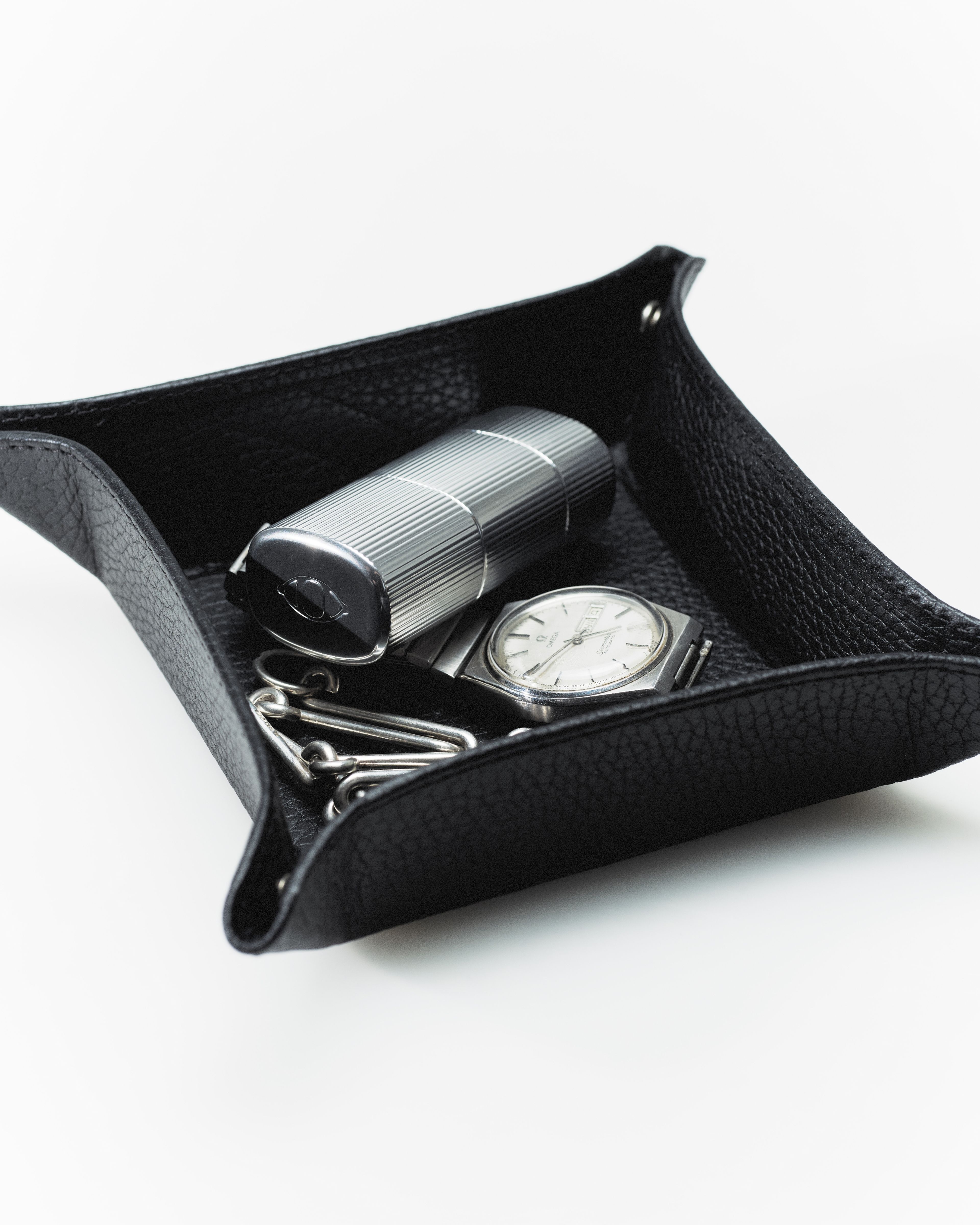 Men's lip balm laying on a grey surface