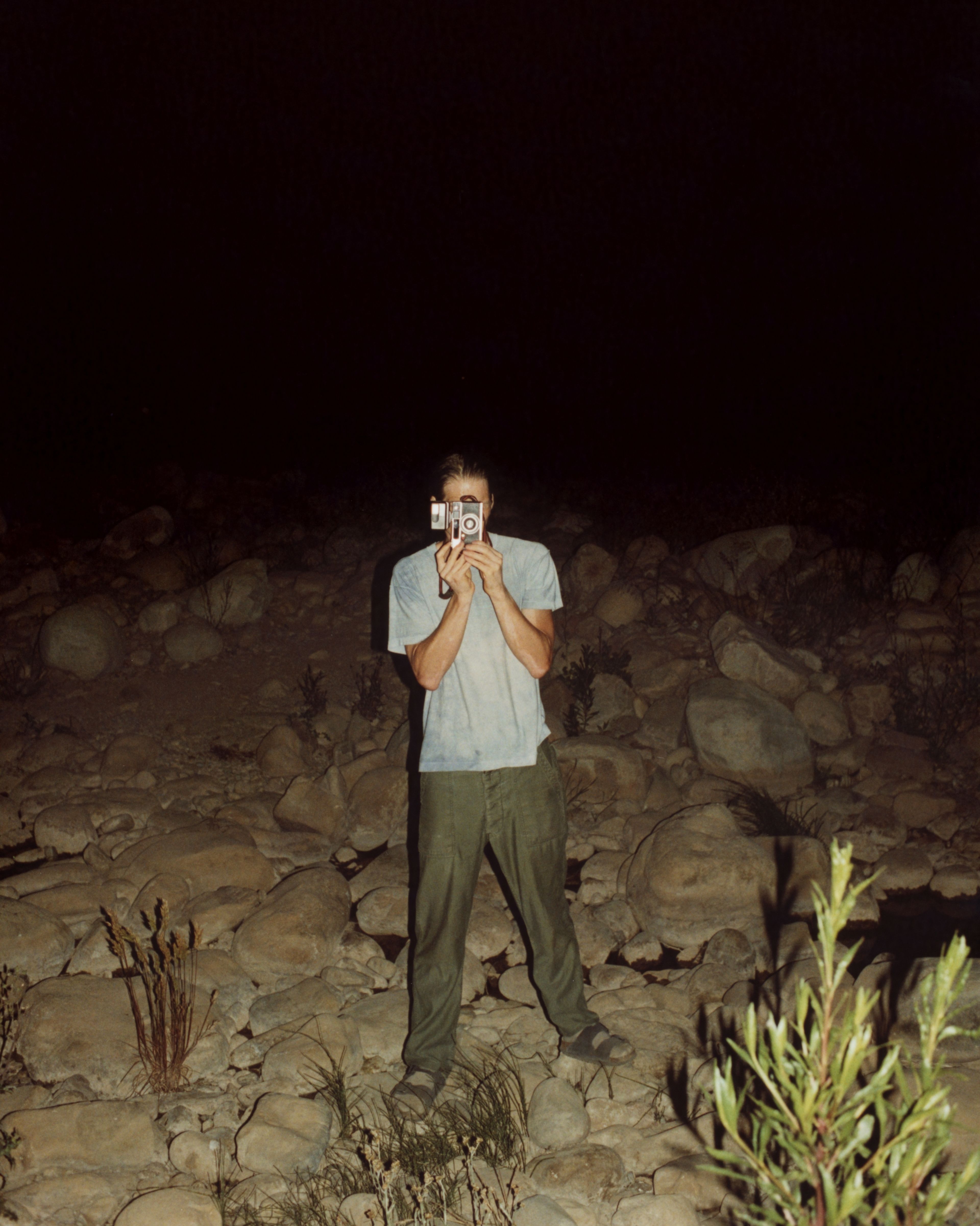 Man standing on a field, taking a photo